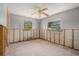 Bedroom with exposed framing, a ceiling fan, and two windows at 4221 Burrows Rd, Zephyrhills, FL 33542