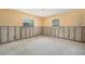 Bedroom featuring exposed framing and two windows at 4221 Burrows Rd, Zephyrhills, FL 33542