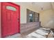 Close-up of the red front door with brick accents on the entryway at 4221 Burrows Rd, Zephyrhills, FL 33542