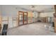 Open-concept living room with exposed framing and a ceiling fan at 4221 Burrows Rd, Zephyrhills, FL 33542
