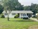 A charming single-story home features a lush front yard and a driveway with parking space for vehicles at 4316 E Knights Griffin Rd, Plant City, FL 33565