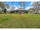 Manicured backyard showing a spacious lawn and two-story screened in patio at 4641 John Moore Rd, Brandon, FL 33511