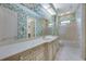 Bathroom with patterned wallpaper, vanity with drawers, and glass enclosed shower at 4641 John Moore Rd, Brandon, FL 33511