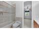 Bathroom boasting tiled shower-tub combination and tan tiling throughout at 4641 John Moore Rd, Brandon, FL 33511