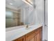 Bathroom features a long countertop, wooden cabinets, and shower-tub with golden fixtures at 4641 John Moore Rd, Brandon, FL 33511
