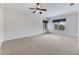 Bright bedroom with neutral carpet, ceiling fan, and window lets in natural light at 4641 John Moore Rd, Brandon, FL 33511