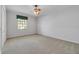 Cozy bedroom has neutral carpet, a ceiling fan, and a window that lets in plenty of light at 4641 John Moore Rd, Brandon, FL 33511