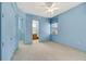 Bright blue bedroom with neutral carpet, closet, window, and an ensuite bathroom at 4641 John Moore Rd, Brandon, FL 33511