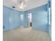 Spacious blue bedroom with walk-in closet, ensuite bathroom, and neutral carpeting at 4641 John Moore Rd, Brandon, FL 33511