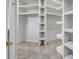 Walk in closet with carpet flooring and lots of white shelving at 4641 John Moore Rd, Brandon, FL 33511