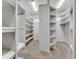 Walk in closet with carpet flooring and lots of white shelving at 4641 John Moore Rd, Brandon, FL 33511