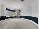 Dining room with bay windows, carpeted floors, and elegant chandelier at 4641 John Moore Rd, Brandon, FL 33511