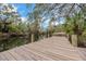 A wooden dock extends into a calm waterway with trees on either side at 4641 John Moore Rd, Brandon, FL 33511