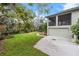 Home showcasing a large lawn, a paved driveway and a two-story screened in patio at 4641 John Moore Rd, Brandon, FL 33511