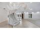 Bright foyer with winding staircase and tile flooring leads into the open-concept living areas at 4641 John Moore Rd, Brandon, FL 33511