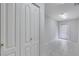 Hallway featuring white doors, white walls, tile flooring, and a rear door at 4641 John Moore Rd, Brandon, FL 33511