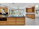 Spacious kitchen with granite countertops, an island, wooden cabinets and tile flooring at 4641 John Moore Rd, Brandon, FL 33511