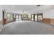 Large living room with gray carpet, lots of bright windows, and access to the backyard at 4641 John Moore Rd, Brandon, FL 33511