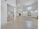 Open living space with tiled flooring, fireplace, spiral stairs, and lots of natural light at 4641 John Moore Rd, Brandon, FL 33511