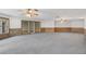 Spacious living room offers gray carpet, lots of bright windows, and white walls at 4641 John Moore Rd, Brandon, FL 33511