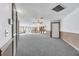 Spacious living room with a gray carpet, wood trim, multiple ceiling fans, and lots of windows at 4641 John Moore Rd, Brandon, FL 33511