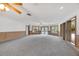A large living room offers gray carpet, beautiful lighting, wood trim, and bright windows at 4641 John Moore Rd, Brandon, FL 33511