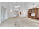 Open living room features a built-in, staircase to the second floor, and elevator at 4641 John Moore Rd, Brandon, FL 33511