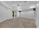 Spacious main bedroom features tray ceiling, ceiling fan, carpet and sliding glass doors to a private balcony at 4641 John Moore Rd, Brandon, FL 33511