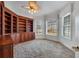 Office with built-in wood bookcases and cabinets, neutral carpet and large windows at 4641 John Moore Rd, Brandon, FL 33511
