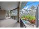 A covered outdoor living space overlooks a pool and spa, surrounded by lush landscaping at 4641 John Moore Rd, Brandon, FL 33511