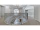 Second floor landing with railing provides views of the foyer and open-concept living space below at 4641 John Moore Rd, Brandon, FL 33511