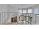 Second floor landing overlooks the Gathering room, pool, and backyard through large windows at 4641 John Moore Rd, Brandon, FL 33511