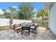 Backyard featuring stamped concrete patio with lounge seating and a sun umbrella at 4726 W Fairview Hts, Tampa, FL 33616