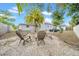 Backyard featuring a fire pit with chairs and a palm tree at 4726 W Fairview Hts, Tampa, FL 33616