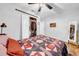 Bright bedroom with a full size bed, mirror, and closet with organizers at 4726 W Fairview Hts, Tampa, FL 33616
