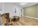 Bedroom featuring light wood floors, light green accent wall and white trim and closet at 4726 W Fairview Hts, Tampa, FL 33616