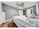 Bedroom with a ceiling fan, hardwood floors, and a closet with organizers at 4726 W Fairview Hts, Tampa, FL 33616