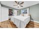 Bedroom with a ceiling fan, hardwood floors, and a closet with organizers at 4726 W Fairview Hts, Tampa, FL 33616