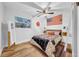 Cozy bedroom featuring an American flag, a ceiling fan and a full size bed at 4726 W Fairview Hts, Tampa, FL 33616