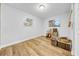 Bedroom with light wood floors, two windows with blinds, and a ceiling light at 4726 W Fairview Hts, Tampa, FL 33616