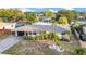Charming single-story home featuring well-manicured landscaping with palm trees and a gray-toned driveway leading to a single car garage at 4726 W Fairview Hts, Tampa, FL 33616