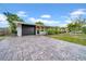 The front exterior shows a paved driveway leading to the garage and front entrance at 4726 W Fairview Hts, Tampa, FL 33616