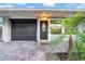 Close up of front door and garage, highlighting the paved driveway and landscaping at 4726 W Fairview Hts, Tampa, FL 33616