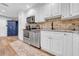 Bright kitchen featuring stainless steel appliances, white cabinets, and granite countertops at 4726 W Fairview Hts, Tampa, FL 33616