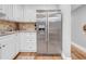 Bright kitchen featuring a stainless steel refrigerator and white cabinets at 4726 W Fairview Hts, Tampa, FL 33616