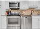 Updated kitchen features modern stainless steel appliances and white cabinets at 4726 W Fairview Hts, Tampa, FL 33616