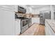 Modern kitchen with stainless steel appliances, white cabinets, and granite counters at 4726 W Fairview Hts, Tampa, FL 33616
