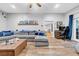 Open-concept living area with wood flooring, stylish furniture, and decor at 4726 W Fairview Hts, Tampa, FL 33616
