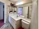 Well-lit bathroom features a classic vanity, a large mirror, and floral accents for a timeless appeal at 502 Chilt Dr, Brandon, FL 33510