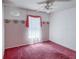 Bedroom featuring pink carpet, window, and floral wallpaper at 502 Chilt Dr, Brandon, FL 33510